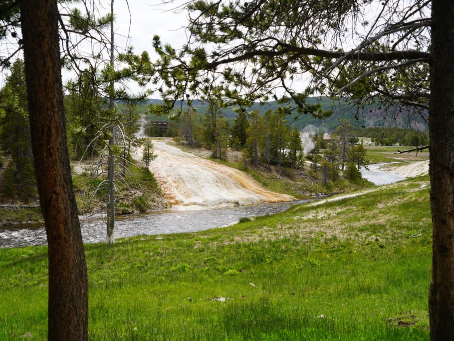 Überall bei Old Faithful brodelt und qualmt es aus dem Boden und heisse Quellen ergiessen sich in den Fluss