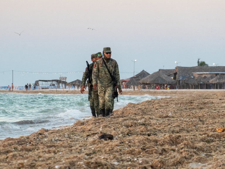 Ein Polizeitrupp marschiert am Meer entlang