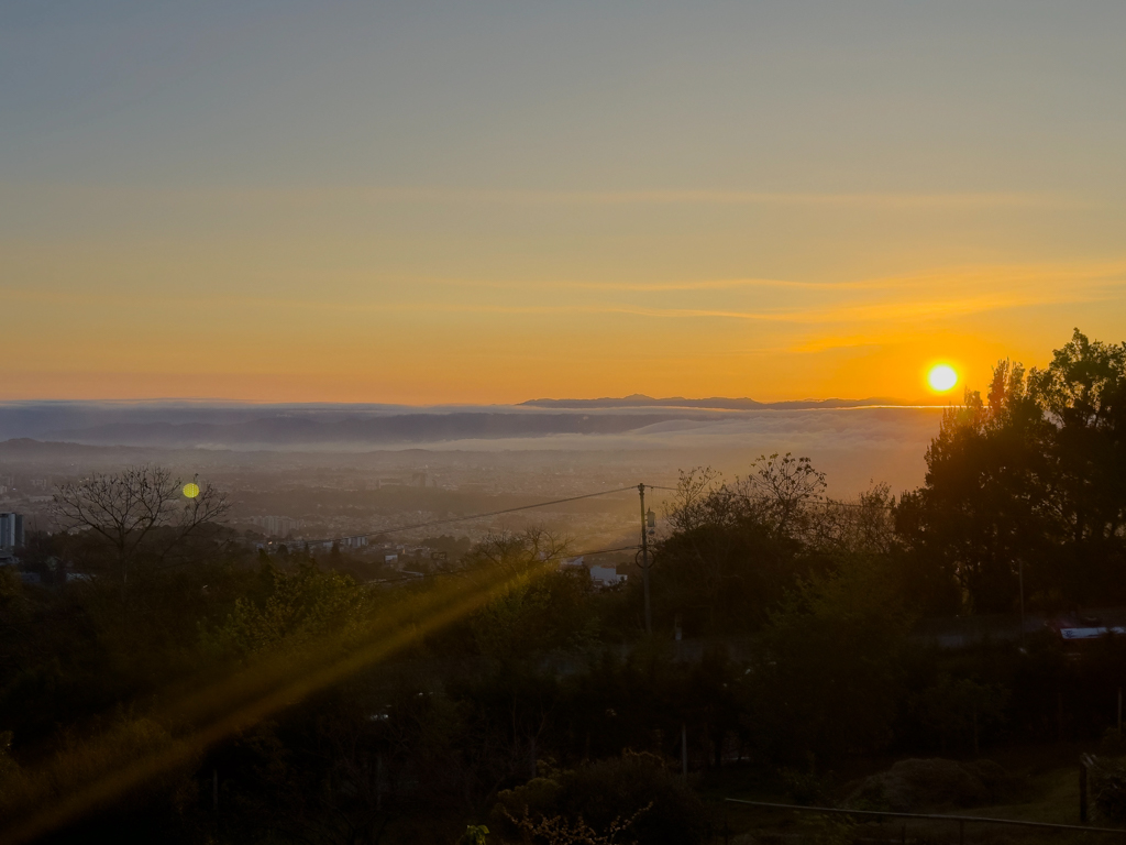Sonnenaufgang. Noch liegt der Morgennebel über der Stadt