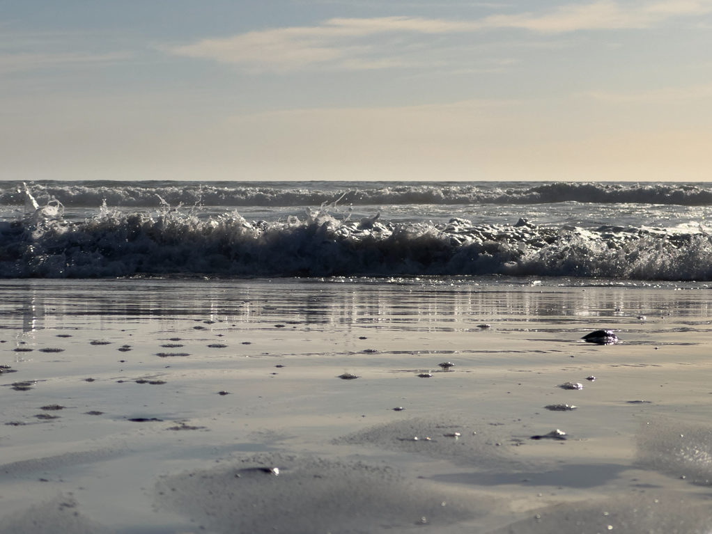 Die Wellen brechen sich kurz vor dem Strand. Ein Surfer Paradies