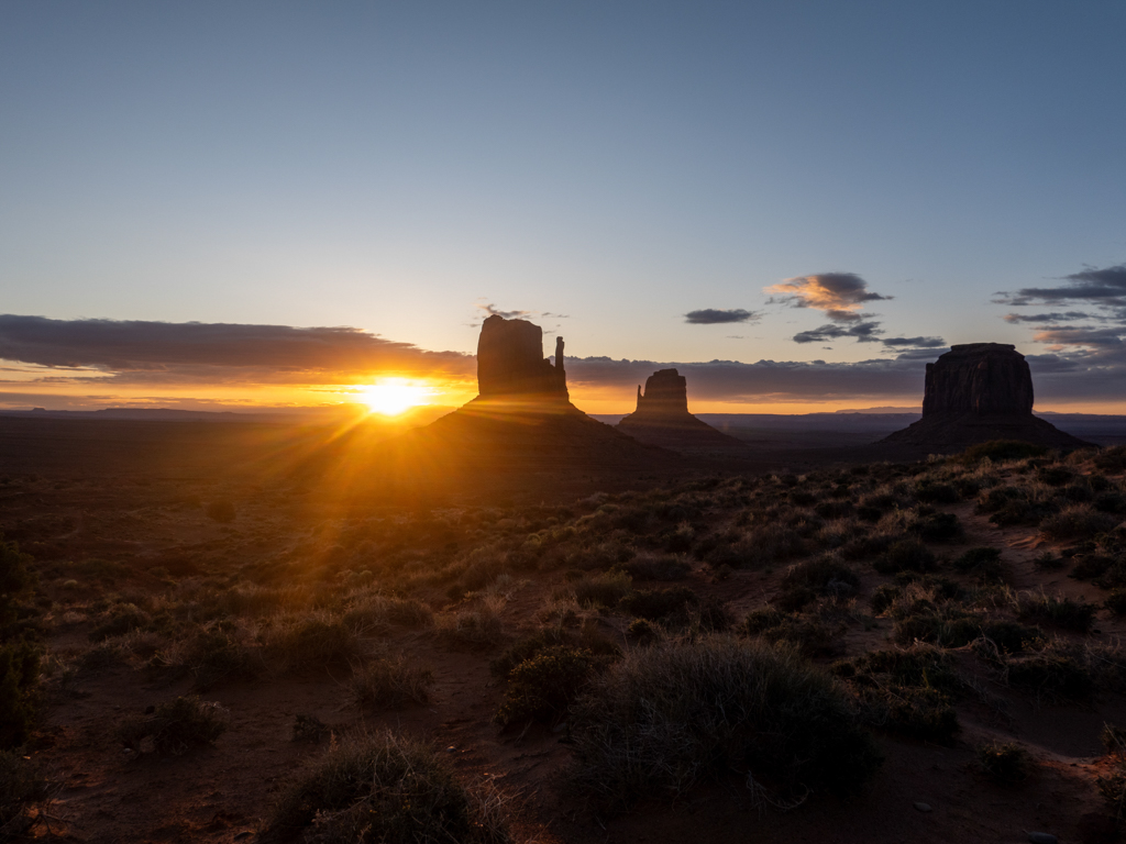 Der noch junge und dunkle Morgen am Monument Valley mit Sonnenaufgang am Horizont
