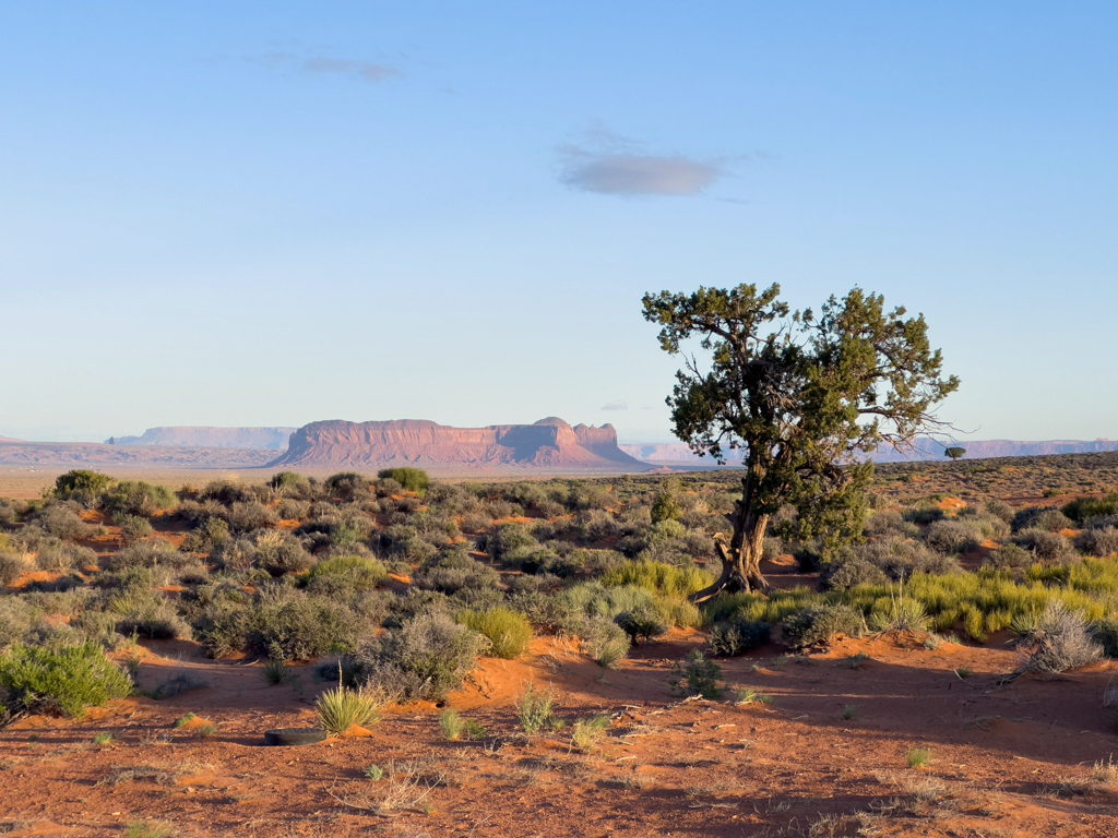 Hinter uns im Monument Valley sehen wir die Sonne aufgehen