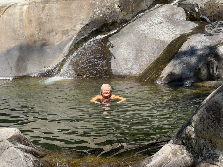 Ma schwimmt im kühlen, klaren Wasser des Little Clear Creek