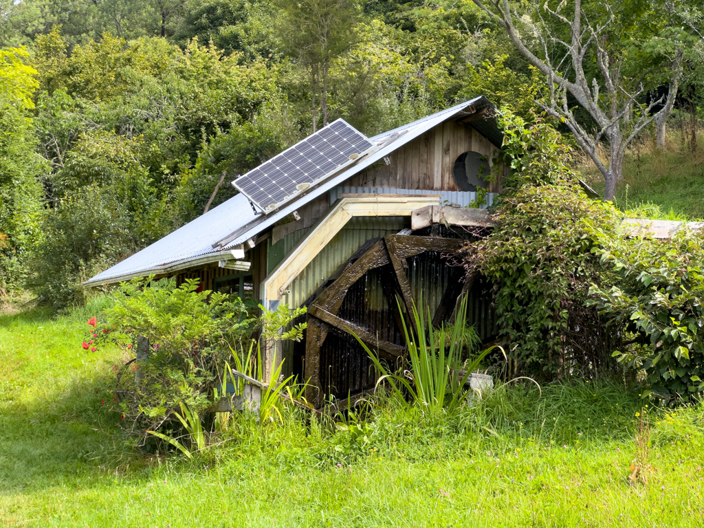 Wasserrad für den Strom mit Solar auf dem Dach